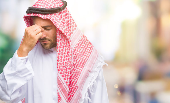 Young handsome man wearing keffiyeh over isolated background tired rubbing nose and eyes feeling fatigue and headache. Stress and frustration concept.