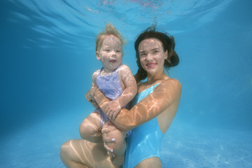 mother and son underwater in the pool