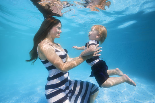 mother and son underwater in the pool
