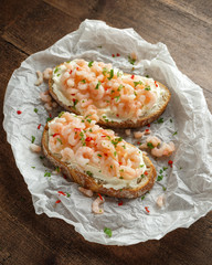 Prawns, shrimp seafood bruschetta with creamy cheese, parsley and chili