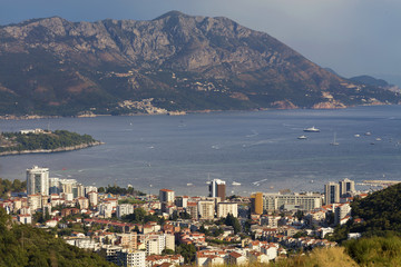 View of the modern city of Budva Riviera on the background of a sea bay and a mountain chain