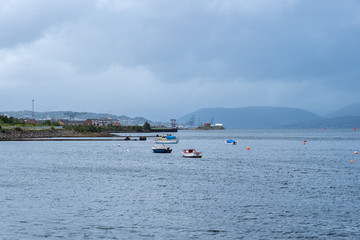 Fototapeta na wymiar West Quey Port Glasgow looking over to the frontage of Greenock with the hillside in the misty distance