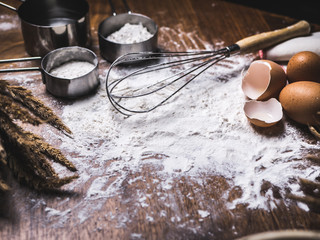 Pastry Baking Accessories Bakery Background with flour and whisk. Ingredients for the preparation of bakery products.