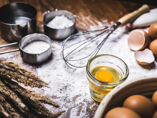 Pastry Baking Accessories Bakery Background with flour and whisk. Ingredients for the preparation of bakery products.