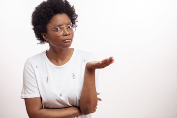 uncertain african woman with open palm asking something. unhappy balck female with puzzled expression. copy space. isolated white background. - obrazy, fototapety, plakaty