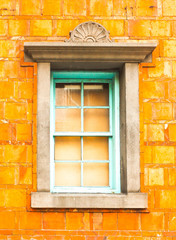 Closeup of decorate window on orange wall