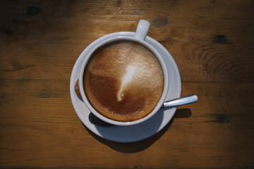cup of coffee on wooden table