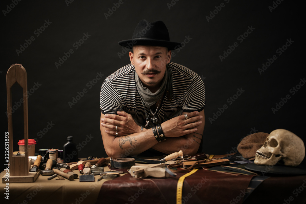 Wall mural Leather craftmans at his workshop. Pieces of leather and scobbler working tools on table. Small Business, Cobblering, Leather Workcraft