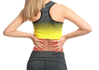 Young woman suffering from back pain on white background