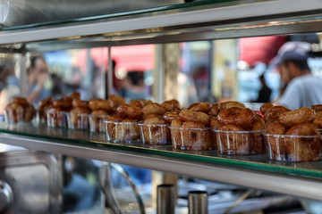 Bowls with fresh lokma on shelf at market. Traditional Turkish treat
