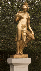 Fototapeta premium Schwetzingen Palace Garden. Golden statue of Diana the huntress with a boar‘s head. Schwetzingen, Baden Wuerttemberg, Germany, Europe