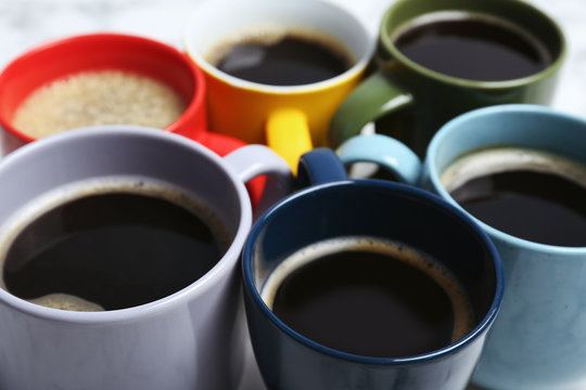 Many cups with tasty aromatic coffee, closeup