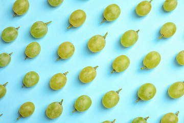 Fresh ripe juicy green grapes on color background, top view