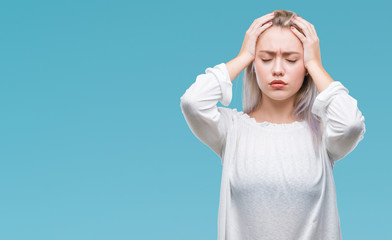 Young blonde woman over isolated background suffering from headache desperate and stressed because pain and migraine. Hands on head.