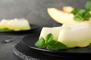 Slices of fresh ripe melon on plate, closeup