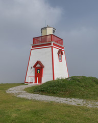 Fox Point Lighthouse in the fog in St. Anthony, Newfoundland, Canada