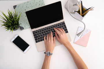 Woman working with laptop at table, top view. Mockup for design