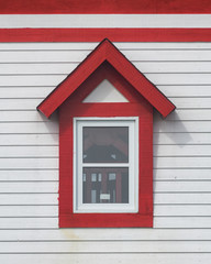 Closeup of red and white Fox Point lighthouse window in St. Anthony, Newfoundland
