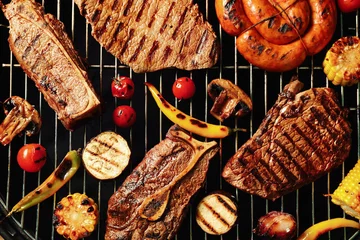 Garden poster Meat Fresh grilled meat steaks and vegetables on barbecue grate, top view