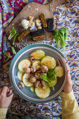 Woman hands holds steamed, cooked, baked and roasted organic assorted vegetables with paprika, herbs, oregano in sieve. Zucchini, mushrooms. Vegan lunch, vegetarian dinner, healthy food