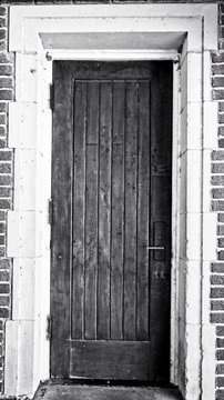 Wooden Door White Doorway in a Red Brick Building B&W