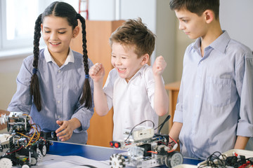 Team of young little technicians working together