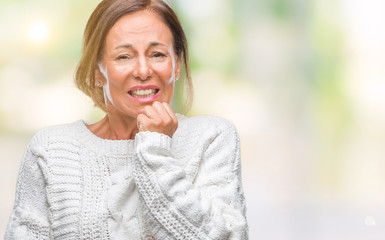 Middle age senior hispanic woman wearing winter sweater over isolated background looking stressed and nervous with hands on mouth biting nails. Anxiety problem.