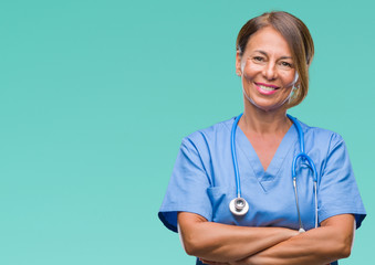 Middle age senior nurse doctor woman over isolated background happy face smiling with crossed arms...