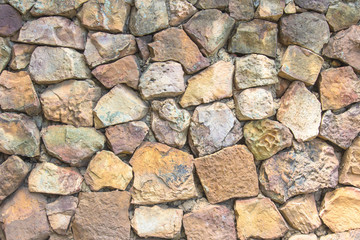 Seamless natural pattern of decorative grey slate stone wall surface of modern style design decorative uneven cracked realmasonry wall of multicolored stones or blocks with cement or sandstone.