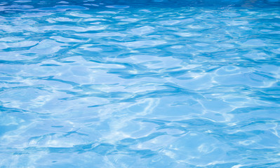 Waves in the pool with blue water