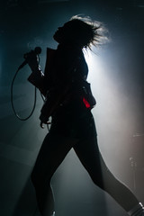 silhouette of young woman dancing on stage