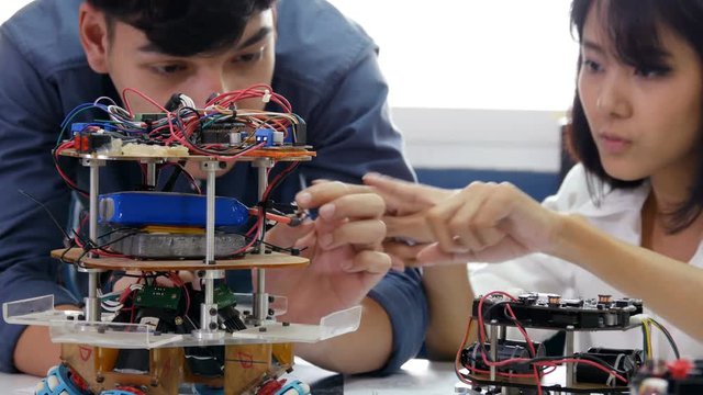 Electronics engineer fixing robotics in laboratory. People with technology or innovation concept. 4K Resolution.