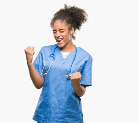 Young afro american doctor woman over isolated background very happy and excited doing winner...