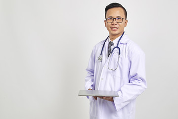 Asians doctor holding a digital tablet