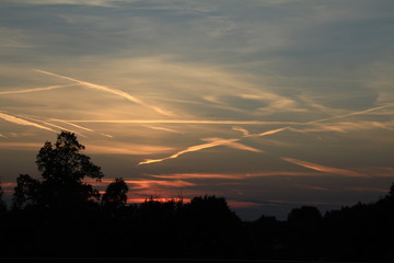 Fototapeta premium sunset with airplane trails