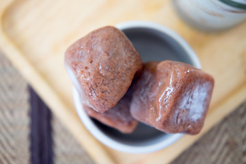 Frozen chocolate ice cubes in a glass