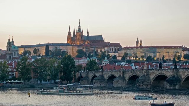 Charles Bridge over the River Vitava, Czech Republic at sunset , timelapse. day to night.