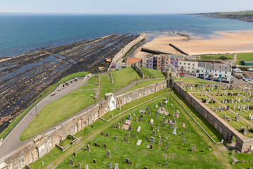 Naklejka premium Aerial view Ruins and graveyard St Andrews cathedral near coast of North Sea, Scotland