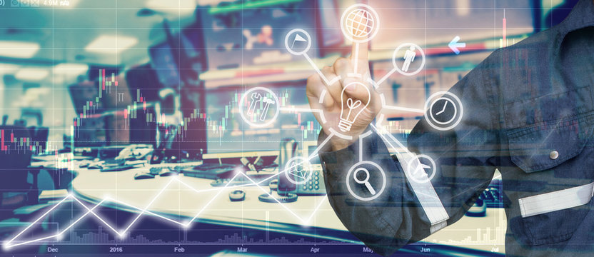 Double exposure of Engineer point in stock trading room with industrial icon computer and graph for Business Trading concept