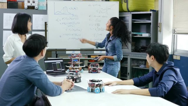 Female engineer present project with team. Team engineer start up for robot project together. People with technology or innovation concept. 4K Resolution.