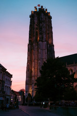 mechelen clock tower against summer evening sky