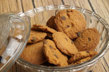 bowl of choco chips cookies on a brown wooden table