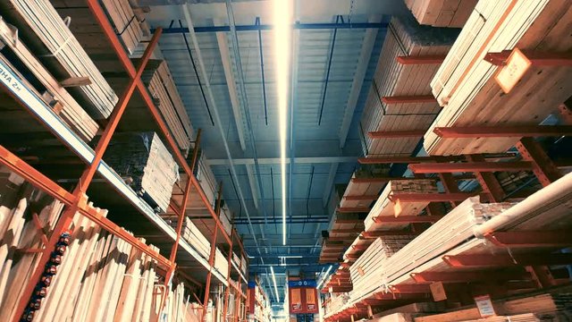 Logistics warehouse interior with wooden products on shelves. Wide angle dolly shot