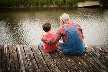 Happy Great Grandfather and Grandson Fishing Together