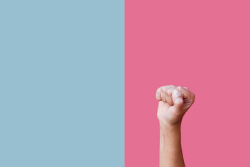 A fist isolated on pink and blue backround