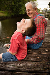 Happy Great Grandfather and Grandson Fishing Together