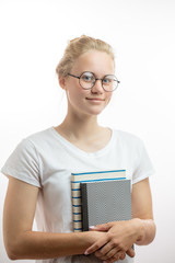 Happy blonde girl, student in spectacles, has positive expression, holds books, rejoices successfully passed exam at university, isolated over white background.