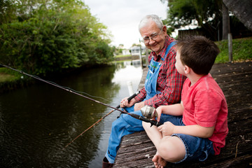 Happy Great Grandfather and Grandson Fishing Together
