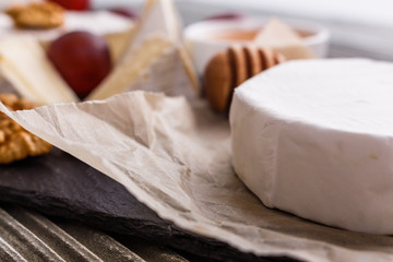 delicious creamy camembert cheese on a wooden rustic background