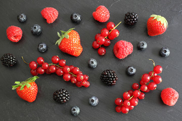 Berries on dark board, top view